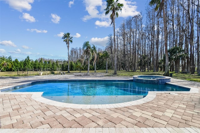 view of pool with an in ground hot tub and a patio area