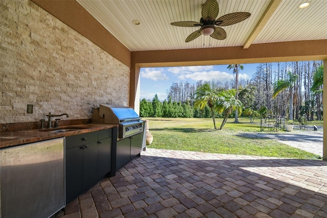 view of patio / terrace with ceiling fan, area for grilling, and sink