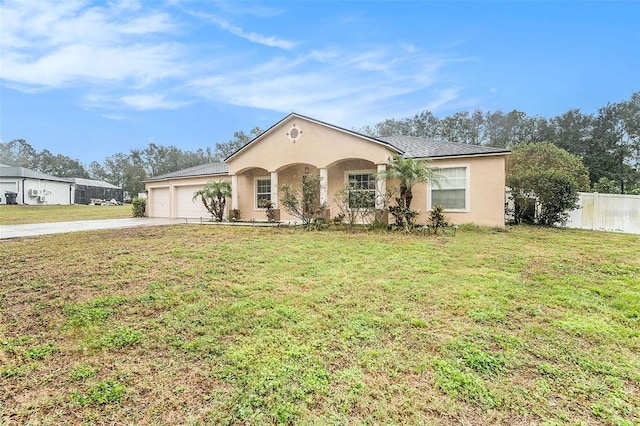 ranch-style house featuring a garage and a front yard