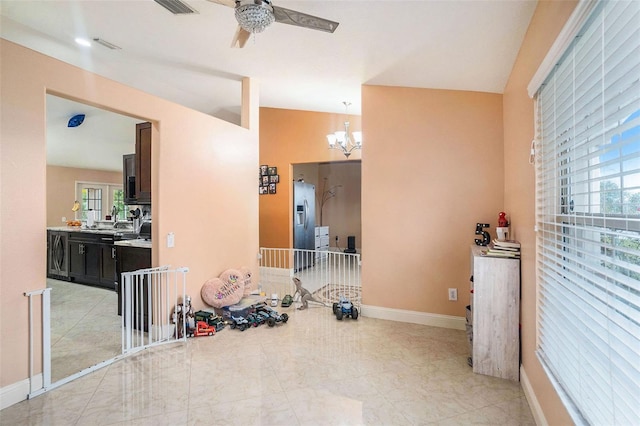 workout room featuring washer / clothes dryer and ceiling fan with notable chandelier