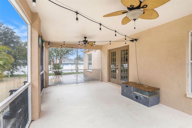 unfurnished sunroom with ceiling fan and french doors