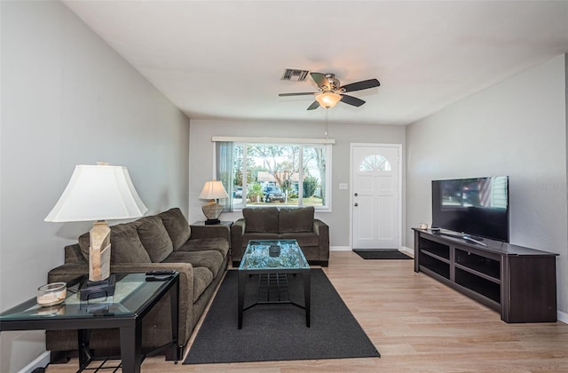 living room featuring ceiling fan and light hardwood / wood-style flooring