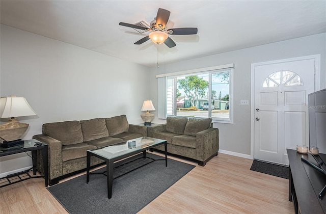 living room featuring ceiling fan and light wood-type flooring