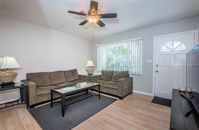 living room featuring ceiling fan and light hardwood / wood-style floors