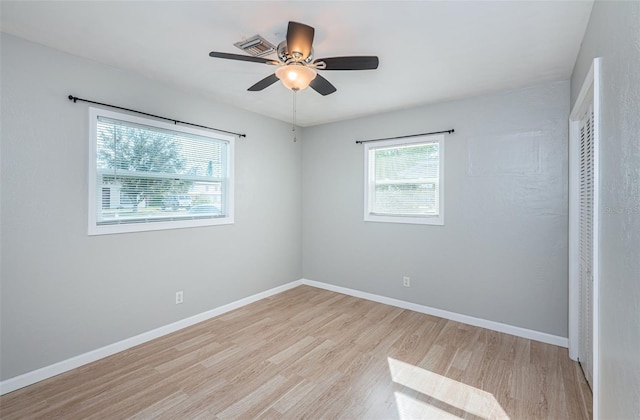 unfurnished bedroom featuring ceiling fan, a closet, and light wood-type flooring