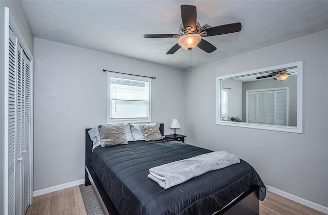 bedroom with ceiling fan, light wood-type flooring, and a closet