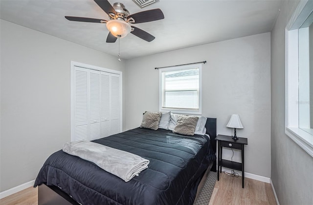 bedroom with a closet, ceiling fan, and light hardwood / wood-style flooring