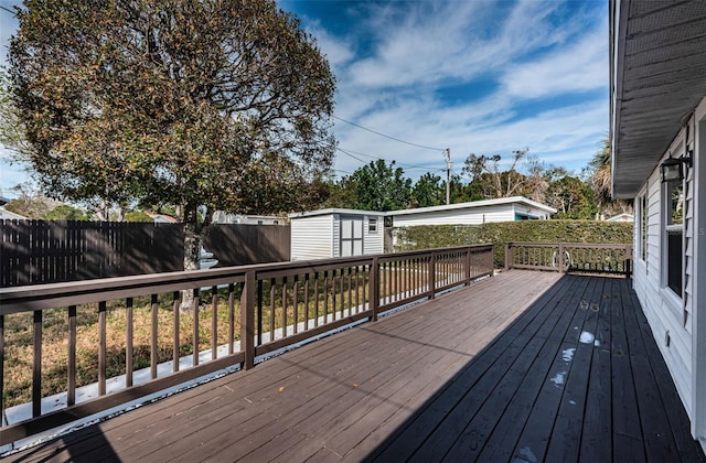 wooden terrace featuring a shed