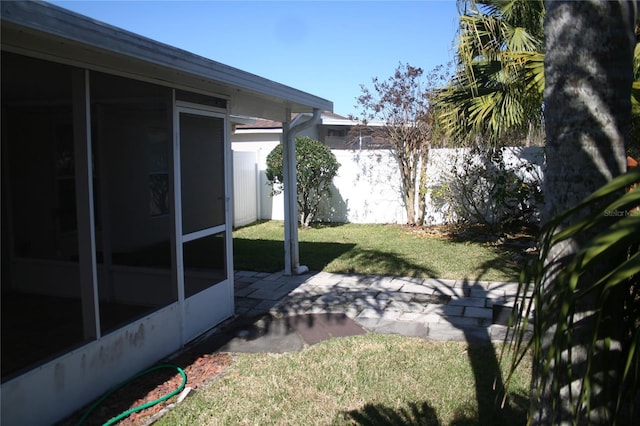 view of yard featuring a patio and a sunroom