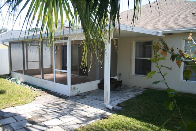 view of home's exterior featuring a yard, a patio area, and a sunroom