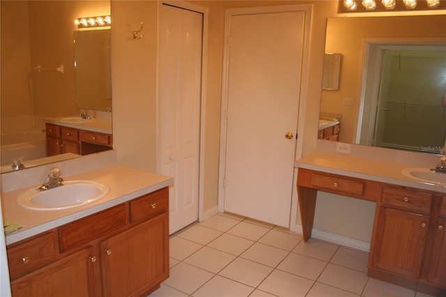 bathroom with vanity, a tub to relax in, and tile patterned flooring