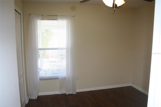 unfurnished room with dark wood-type flooring and ceiling fan