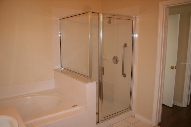 bathroom featuring tile patterned floors and shower with separate bathtub