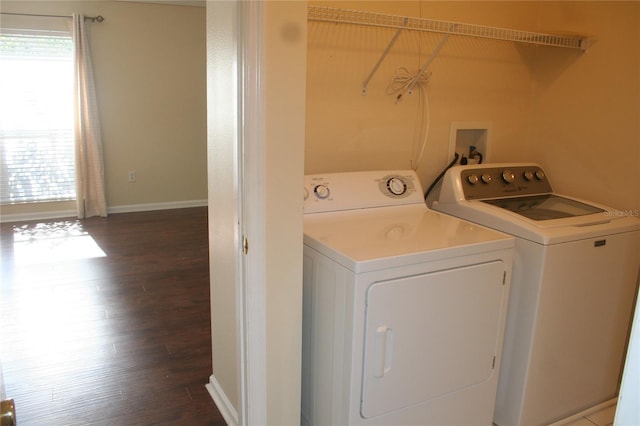 laundry area with dark hardwood / wood-style flooring and washing machine and clothes dryer