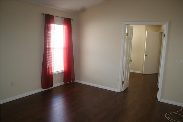 empty room featuring dark wood-type flooring