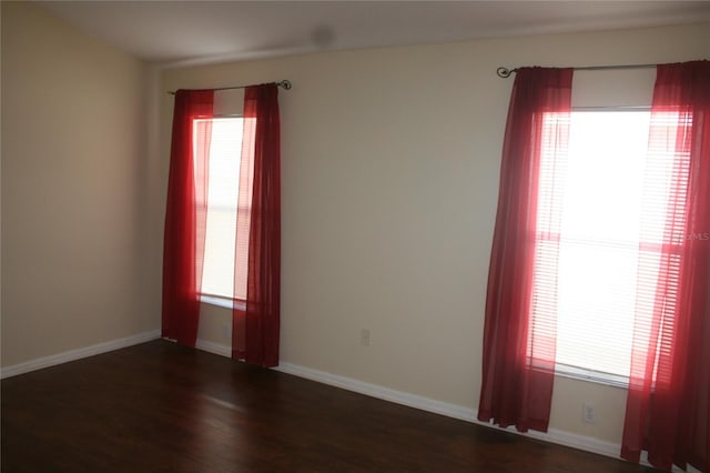 unfurnished room featuring dark wood-type flooring