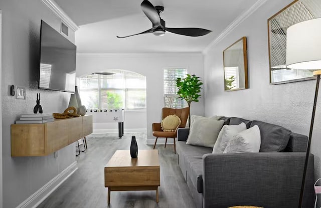 living room with crown molding, hardwood / wood-style floors, and ceiling fan