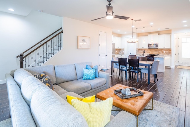 living room with ceiling fan and dark hardwood / wood-style flooring