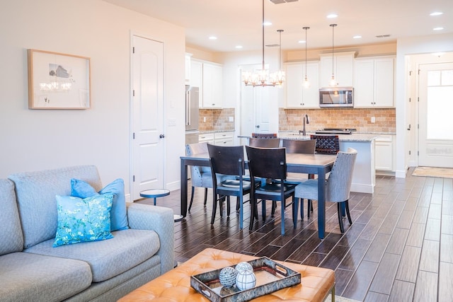 dining space with a chandelier and sink