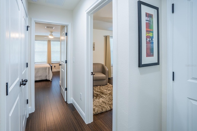 hallway with dark wood-type flooring