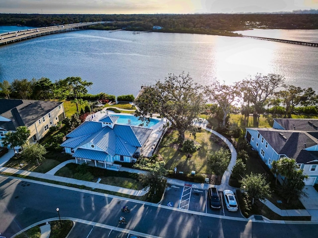 aerial view at dusk featuring a water view