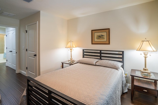 bedroom featuring dark wood-type flooring