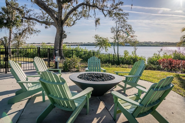 view of patio / terrace featuring a water view and an outdoor fire pit