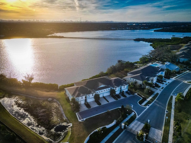 aerial view at dusk with a water view