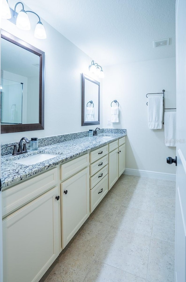 bathroom with vanity and a textured ceiling