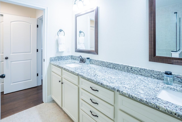 bathroom with vanity and hardwood / wood-style floors