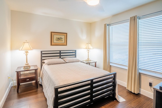 bedroom with dark hardwood / wood-style floors and ceiling fan