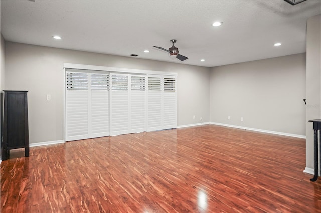 interior space featuring wood-type flooring, a textured ceiling, and ceiling fan