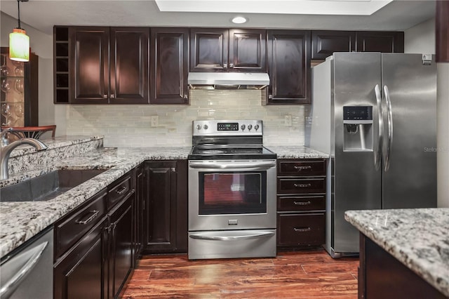 kitchen with sink, appliances with stainless steel finishes, hanging light fixtures, dark brown cabinetry, and dark hardwood / wood-style flooring