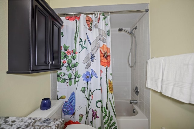 bathroom featuring shower / tub combo and toilet