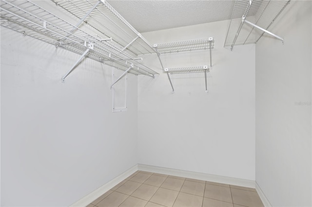 walk in closet featuring tile patterned flooring