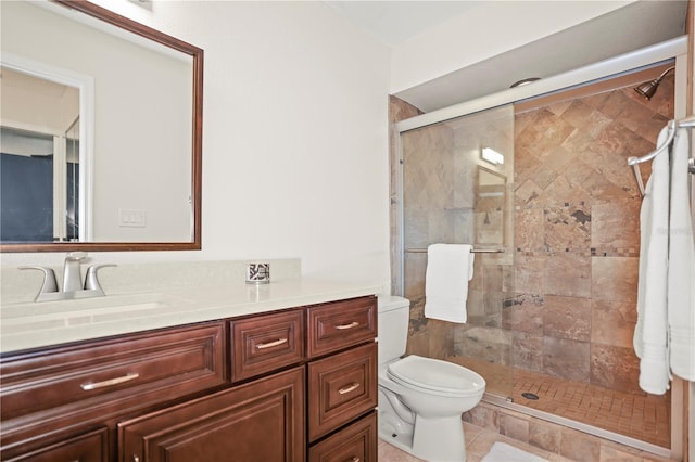 bathroom featuring vanity, an enclosed shower, and toilet