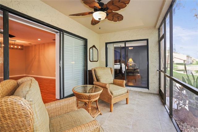 sunroom featuring ceiling fan