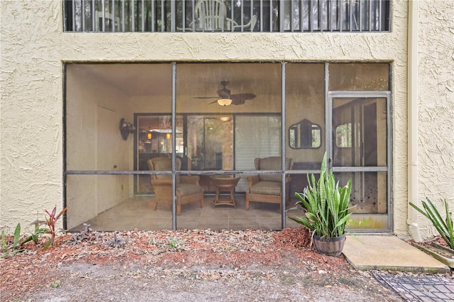 property entrance featuring ceiling fan, a patio, and a balcony