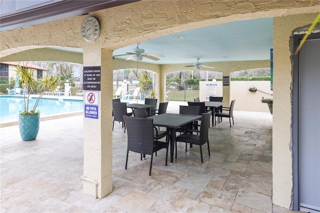 view of patio featuring ceiling fan and a community pool