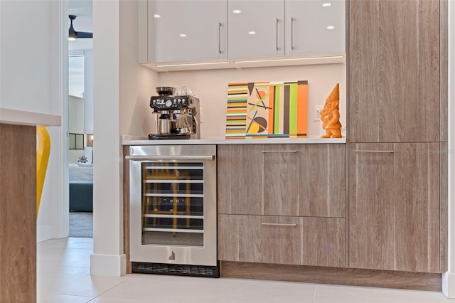 bar with white cabinetry, light tile patterned floors, and wine cooler