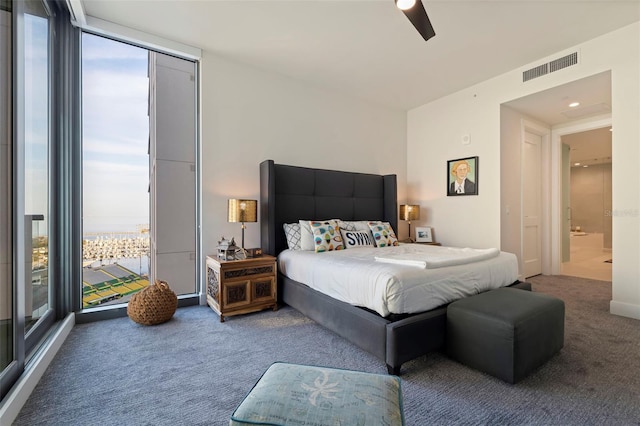 bedroom with floor to ceiling windows, ceiling fan, and carpet flooring