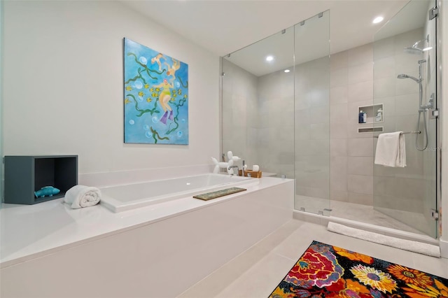 bathroom with tile patterned flooring and separate shower and tub