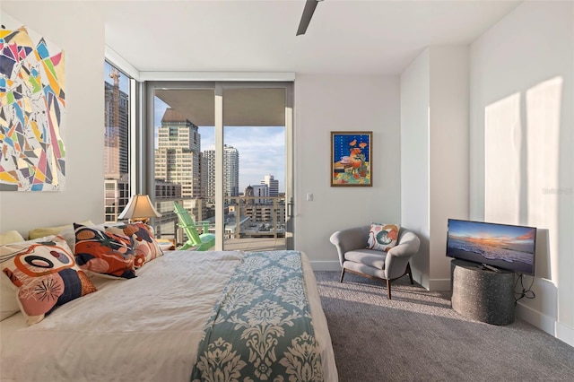 bedroom with access to exterior, floor to ceiling windows, ceiling fan, and carpet