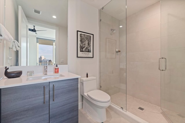 bathroom with vanity, toilet, and a shower with shower door