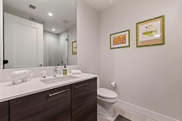 bathroom featuring a shower with door, vanity, tile patterned flooring, and toilet