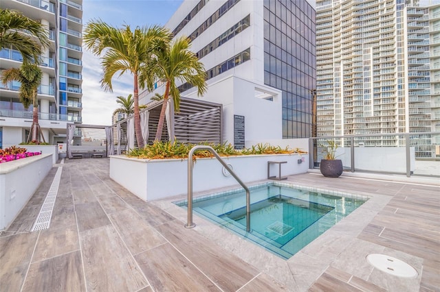 view of pool featuring a patio area and a hot tub