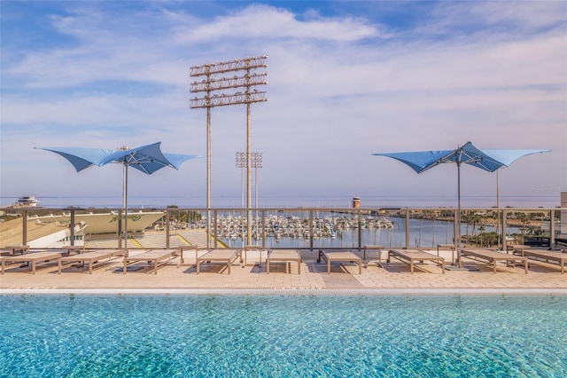 view of pool featuring a beach view and a water view