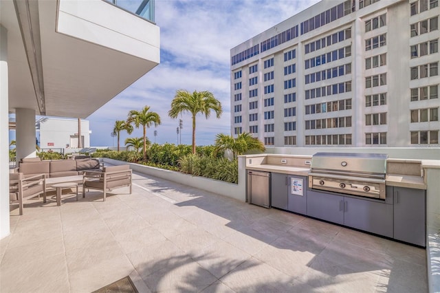 view of patio with a grill, outdoor lounge area, and exterior kitchen