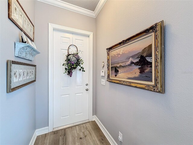 doorway to outside with crown molding and hardwood / wood-style flooring