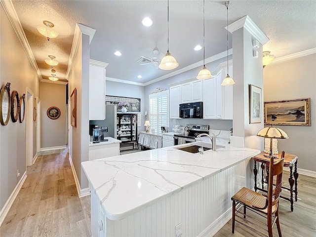 kitchen featuring pendant lighting, electric stove, white cabinetry, light stone countertops, and kitchen peninsula